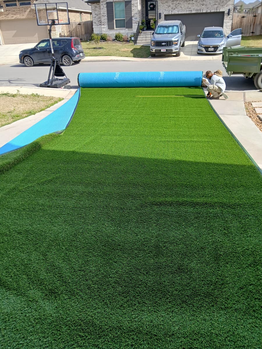 Artificial turf rolled out and measured for cutting